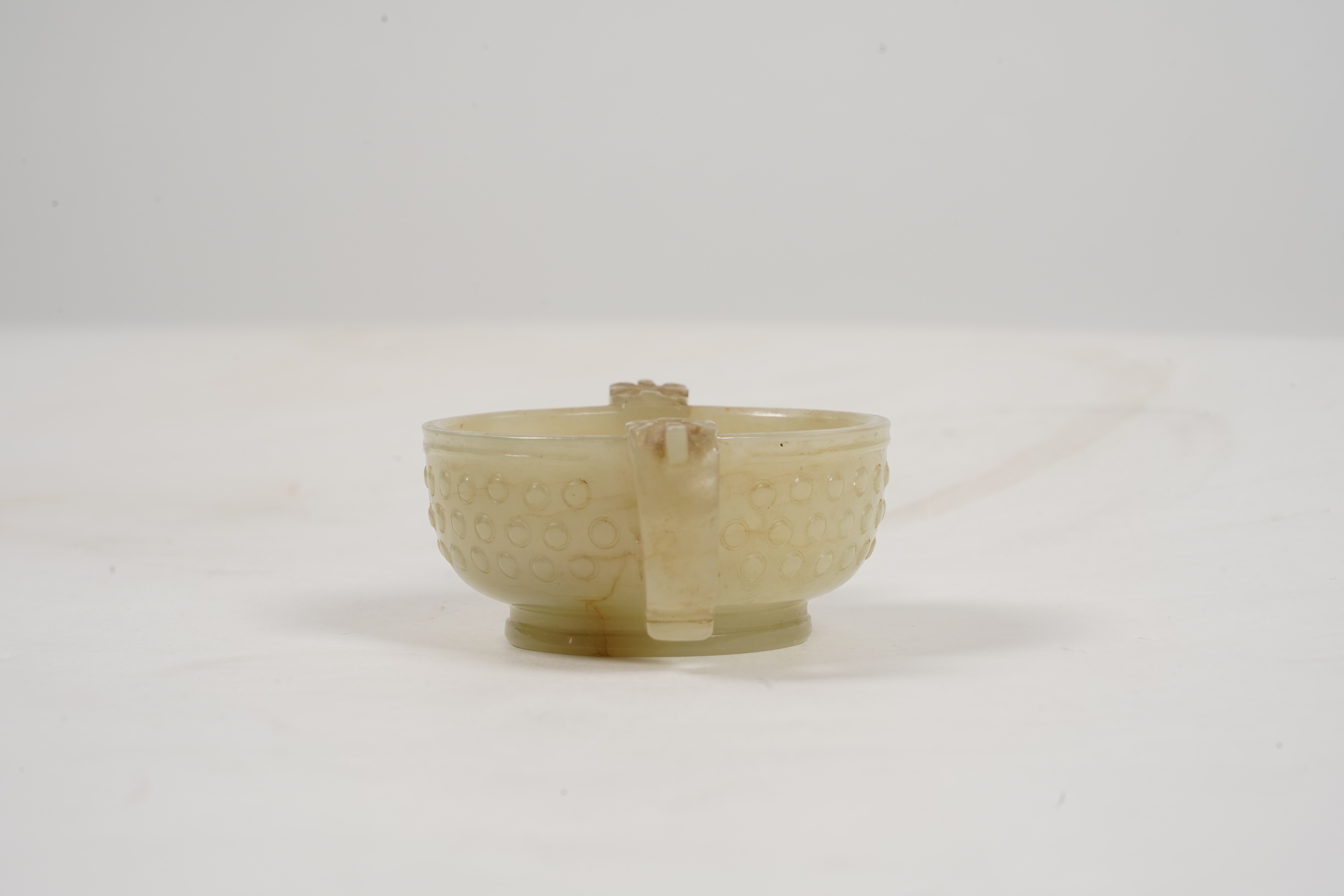 A Chinese pale celadon and russet veined jade cup, 17th century
